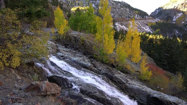 Waterfall flowing down canyon along the Millon Dollar Highway in Colorado.