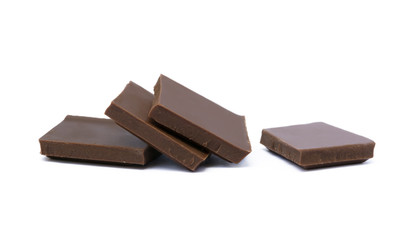 Milk chocolate pieces isolated on white background