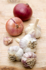 Garlic and onion on a wooden background. Selective focus.