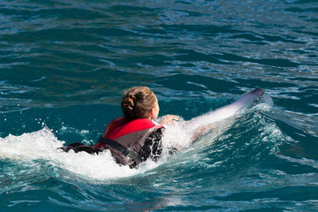 Girl and dolphin swim together