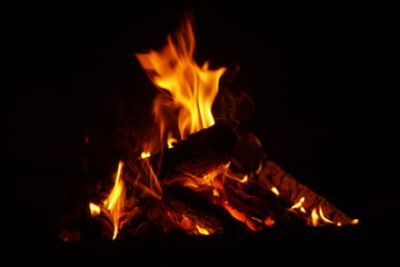 Fire burning in the fireplace on dark background