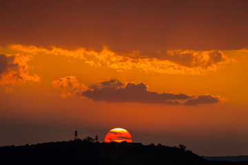 Fototapeta na wymiar The sun descends below the horizon in the Masai Mara, Kenya