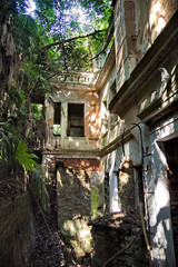 Fototapeta premium Overgrown ruins of abandoned mansion, Abkhazia. Green post-apocalyptic concept