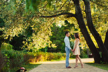 Young loving couple walking in the park