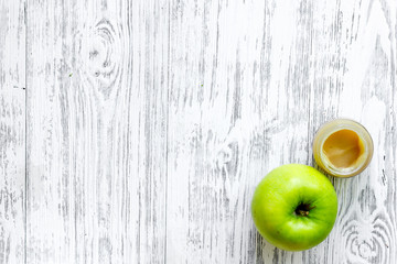 Apple puree for baby on light wooden table background top view copyspace