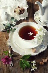 Vintage style: Tea drinking with jasmine tea. Toned image