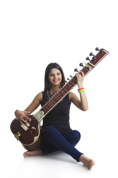 Young woman playing the sitar
