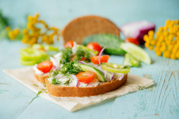 Sandwich with herb pesto and edible nasturtium flowers