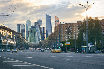 Fototapeta na wymiar Cityscape at sunset with the city traffic and skyscrapers at background