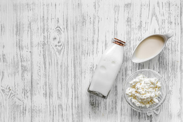 Farm dairy products. Milk and cottage on light wooden background top view copyspace