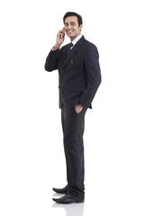 Portrait of businessman talking on a mobile phone 