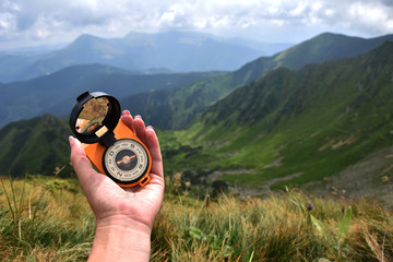 Fototapeta na wymiar Compass in the mountains, travel path tourism, summer