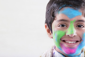 Boy with holi colours on his face 