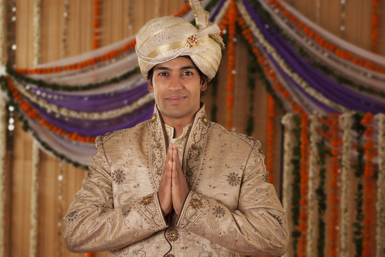 Portrait of Indian groom greeting 