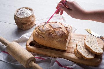 Freshly baked bread on wooden cutting board, Slice bread, wheat flour and cutting knife