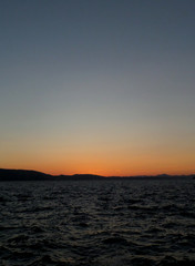 Fototapeta na wymiar Orange color sunset afterglow on deep blue sky over the North Sea in Bergen, Norway