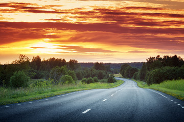 asphalt road view in countryside at beautiful sunset