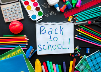 Back to school concept.School and office supplies on black background. Flat lay with copy space.