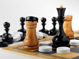 The chess pieces and checkers placed on the chessboard.