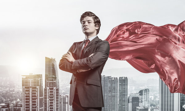 Concept of power and sucess with businessman superhero in big ci
