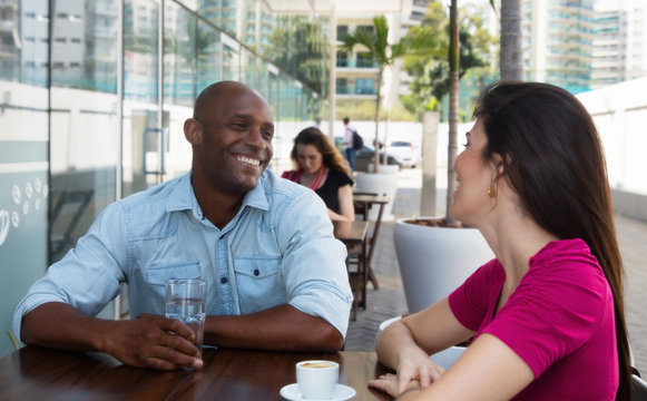 African American Man Flirting With Caucasian Woman At Restaurant