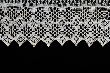 Old napkin embroidery of white thread handmade on a dark background in vintage retro antique style - obrazy, fototapety, plakaty