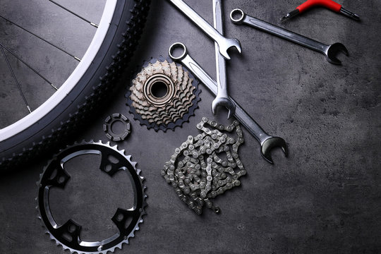 Fototapeta Bicycle parts and repair tools on gray background