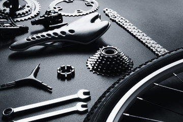 Bicycle parts and repair tools on gray background