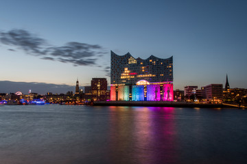 Fototapeta premium Hamburg, Germany, Panorama of the Harbour at night. With the colored illuminated music hall at Christopher Street Day