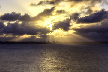 rays of sun through the clouds over the sea