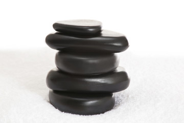 Stacked massage stones on a towel 