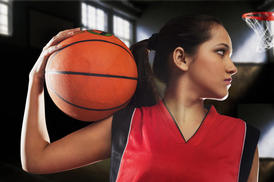 Girl posing with a basketball 