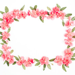 Obraz na płótnie Canvas Floral frame with space for text made of pink hydrangea flowers, green leaves, branches on white background. Flat lay, top view. Floral background. Frame of flowers.