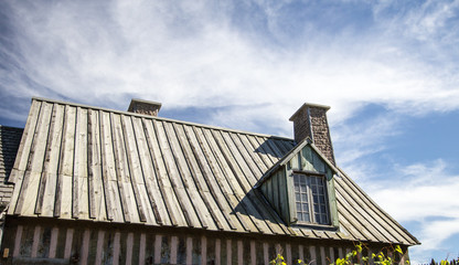 Small Cottage With Wooden Roof. Wood roof, chimney and window dormer of an older English style...