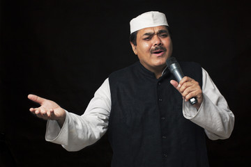 Male politician talking on a microphone 