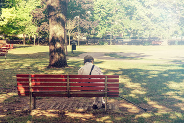 lonely senior sitting on a bench