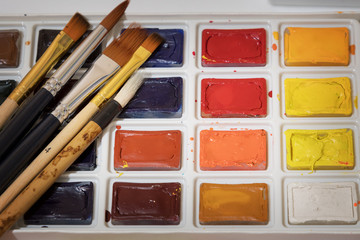Watercolors in a box with brushes