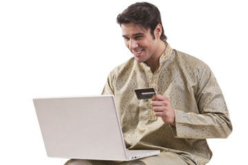 Bengali man with laptop and credit card