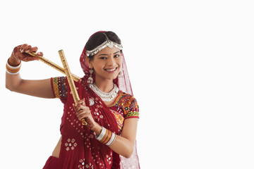 Female dandiya dancer dancing with sticks 