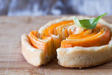 Homemade quiche tart with carrot, eggplant and cabbage roulade with soft cheese
