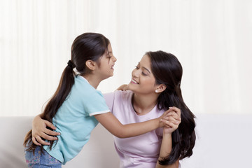 Happy mother and daughter dancing 
