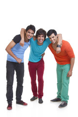 Full length of three male friends smiling together over white background