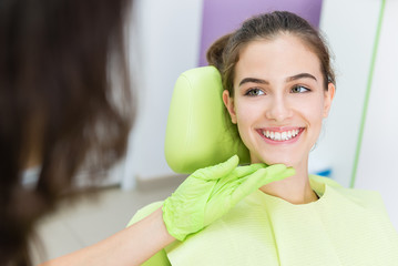 Dentist exam of young teen girl teeth.Unrecognizable doctor