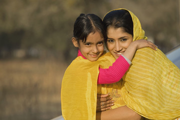 Rural mother hugging her daughter 