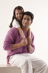 Portrait of father and daughter over white background 