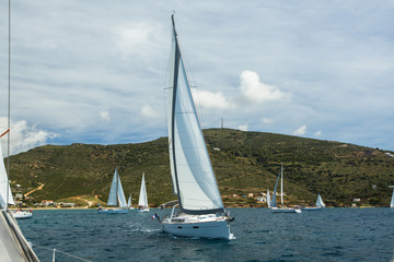 Fototapeta na wymiar Regatta sailing yacht boats on the waves in the Aegean sea.