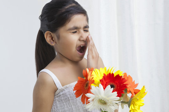 Little Girl With Flowers About To Sneeze