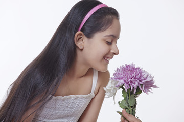 Little girl smelling flowers 