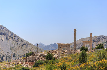 Fototapeta premium Ancient city with arches and columns in mountains