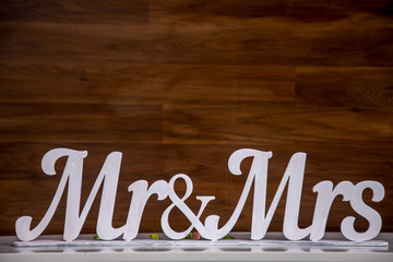 Mr and Mrs sign.on the wooden background.